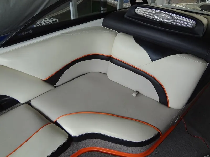 Slide: The Image of 2010 Malibu VLX WAKESETTER boat interior with stylish white and orange seating. - 9