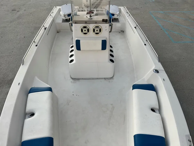 Slide: The Image of 2000 Pathfinder 2200 boat interior with blue and white seating, center console, and speakers. - 10