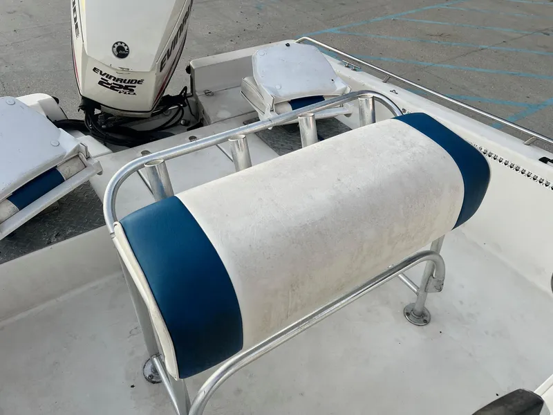 Slide: The Image of Pathfinder 2200 boat interior with Evinrude 225 motor, featuring blue and white seating. - 5