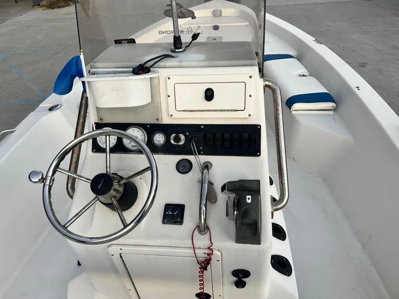 Slide: The Image of Steering console of a 2000 Pathfinder 2200 boat with gauges and controls. - 9
