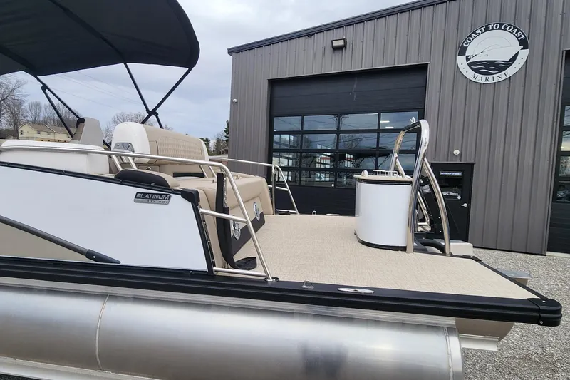 Slide: The Image of 2025 Avalon Platinum Catalina 2585 Cruise Rear Bench pontoon boat at a marina. - 14