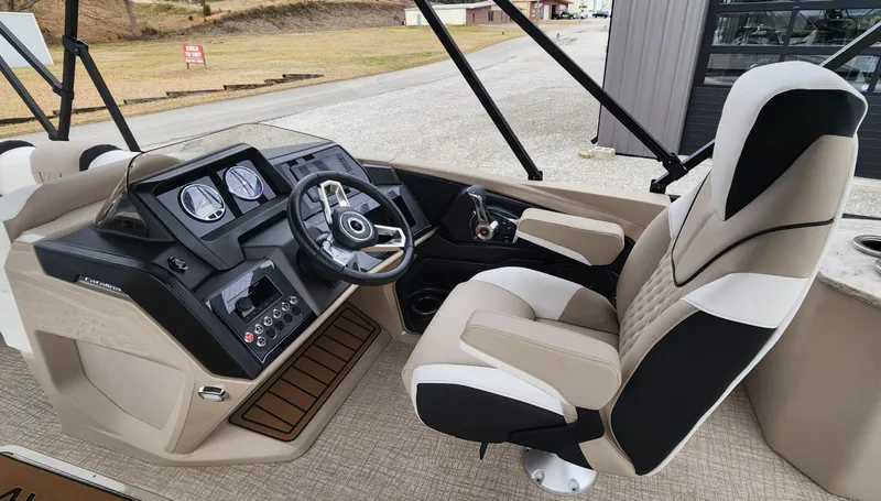 Slide: The Image of 2025 Avalon Platinum Catalina 2585 Cruise Rear Bench boat interior with modern dashboard and seating. - 7