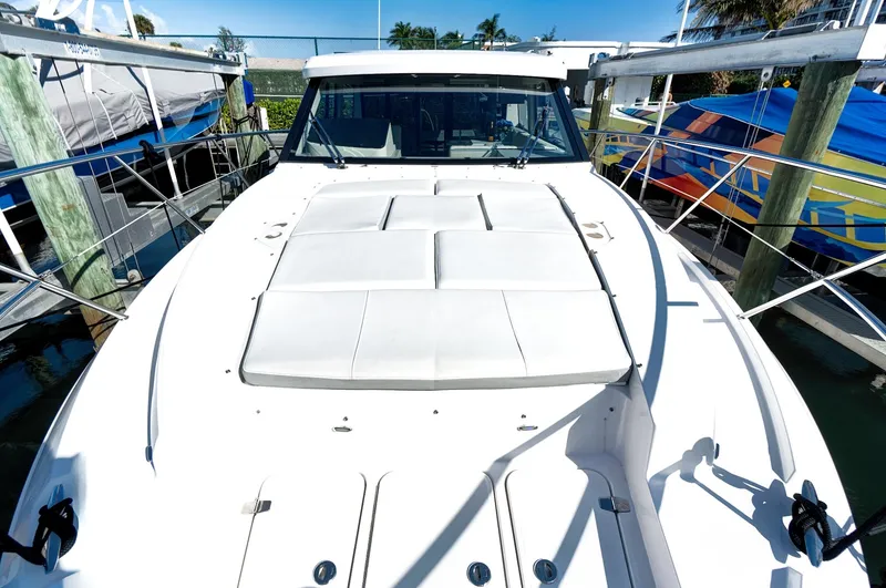 Slide: The Image of 2022 Regal 38 XO yacht with sleek white deck, docked at marina. - 10