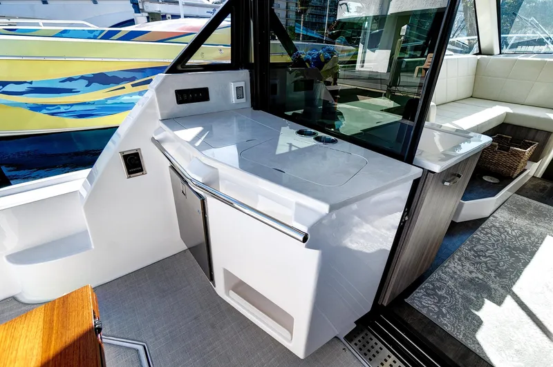 Slide: The Image of 2022 Regal 38 XO yacht interior with sleek kitchenette and modern design. - 15