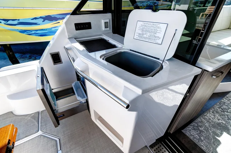 Slide: The Image of 2022 Regal 38 XO yacht interior with kitchenette and storage. - 16