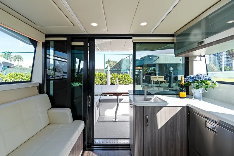 Slide: The Image of Luxurious interior of 2022 Regal 38 XO yacht with modern seating and kitchenette. - 18