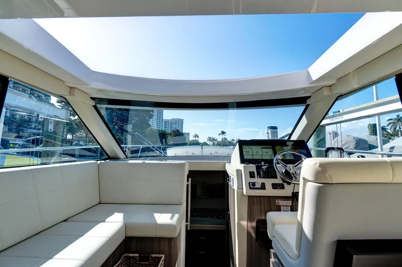 Slide: The Image of Interior view of 2022 Regal 38 XO yacht cockpit with modern seating and controls. - 19