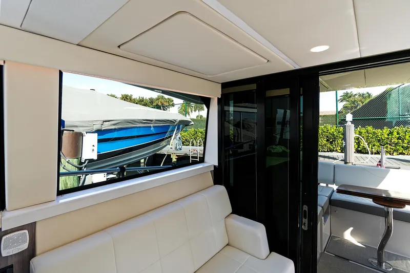 Slide: The Image of Interior view of 2022 Regal 38 XO yacht with seating and outdoor access. - 20