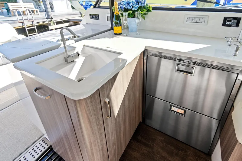 Slide: The Image of Modern kitchen area on 2022 Regal 38 XO yacht with sink and stainless appliances. - 22