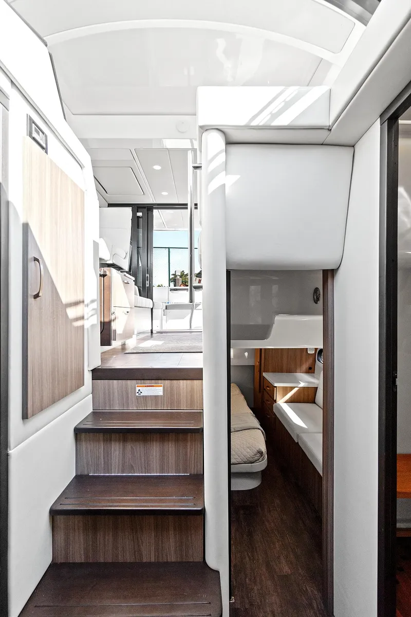 Slide: The Image of Interior of 2022 Regal 38 XO yacht, featuring modern design and wooden stairs. - 28