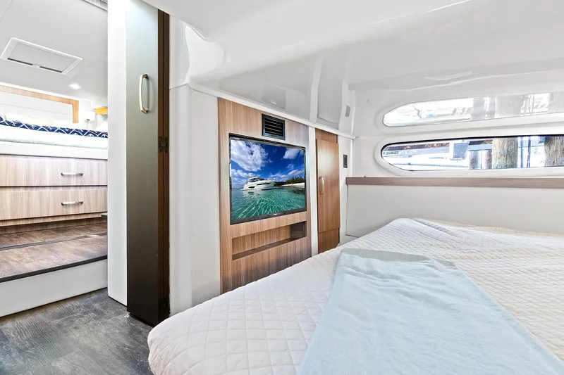 Slide: The Image of Interior of 2022 Regal 38 XO yacht with bed, TV, and window view. - 29