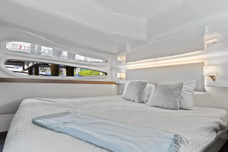 Slide: The Image of Luxurious interior cabin of 2022 Regal 38 XO yacht with modern bedding. - 30