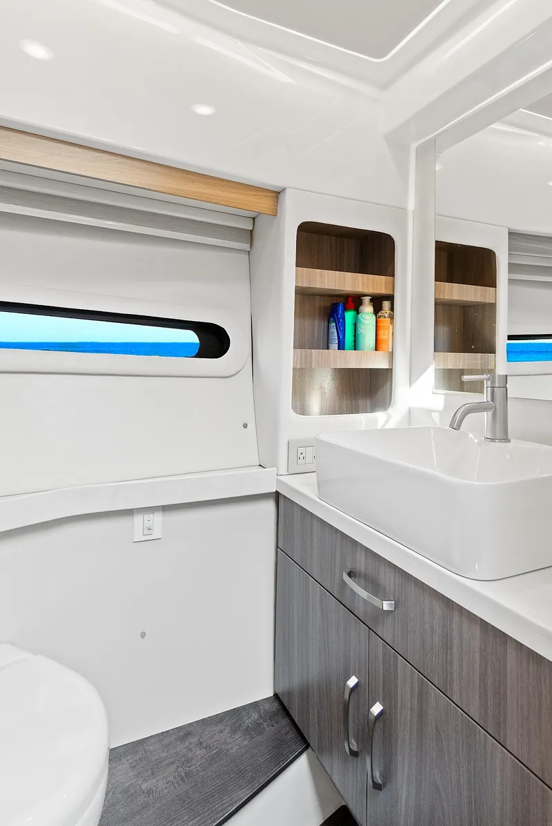 Slide: The Image of Modern bathroom interior of 2022 Regal 38 XO yacht, featuring sleek design and ample storage. - 32