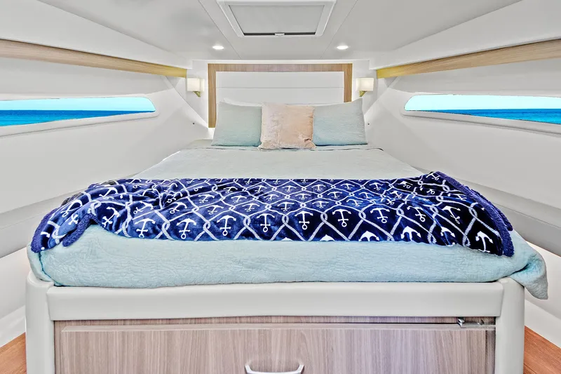Slide: The Image of Luxurious cabin interior of 2022 Regal 38 XO yacht with cozy bedding. - 33