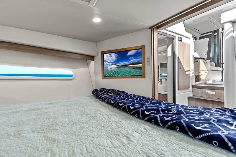 Slide: The Image of Interior of 2022 Regal 38 XO yacht with cozy bed and nautical decor. - 34