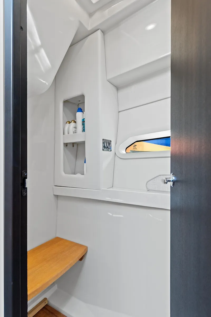 Slide: The Image of 2022 Regal 38 XO boat interior with modern bathroom design and wooden accents. - 36