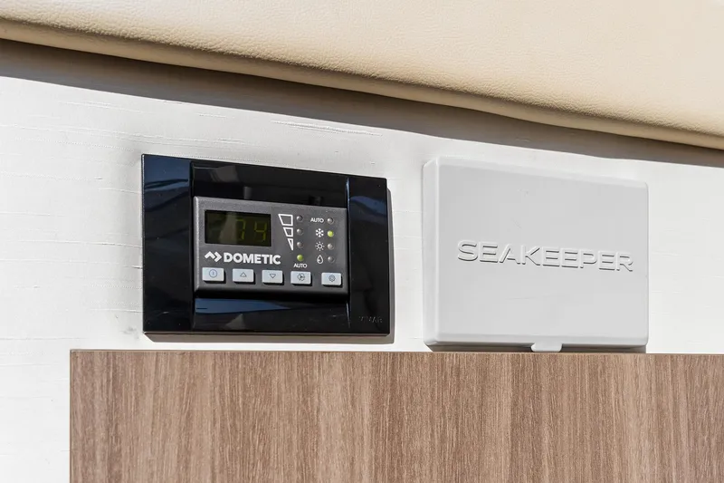Slide: The Image of Dometic and Seakeeper control panels on 2022 Regal 38 XO yacht interior. - 38