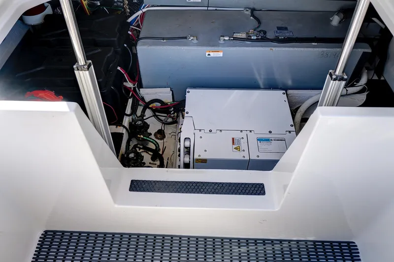 Slide: The Image of Engine compartment of 2022 Regal 38 XO boat, showcasing mechanical components and wiring. - 42