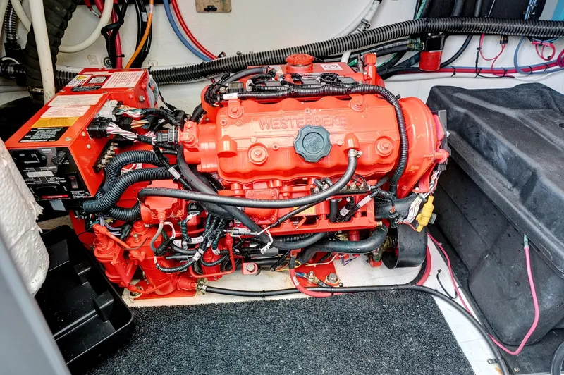 Slide: The Image of Engine compartment of a 2022 Regal 38 XO boat, featuring a red Westebeke engine. - 44