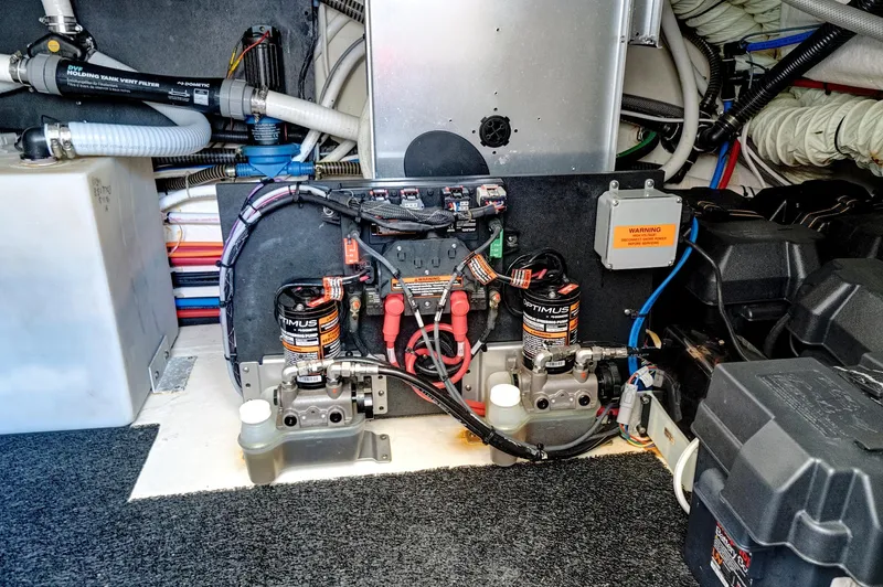 Slide: The Image of Engine compartment of 2022 Regal 38 XO boat, showcasing wiring and battery systems. - 47