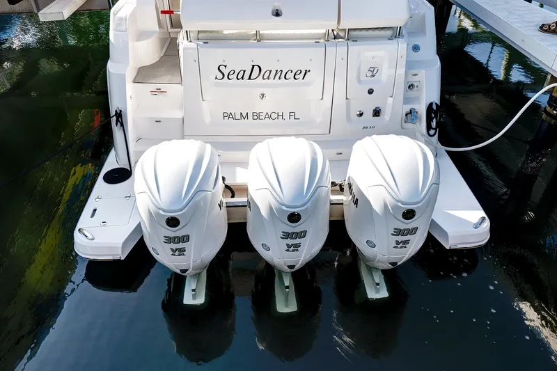 Slide: The Image of 2022 Regal 38 XO boat with triple 300 horsepower engines, docked in Palm Beach, FL. - 6