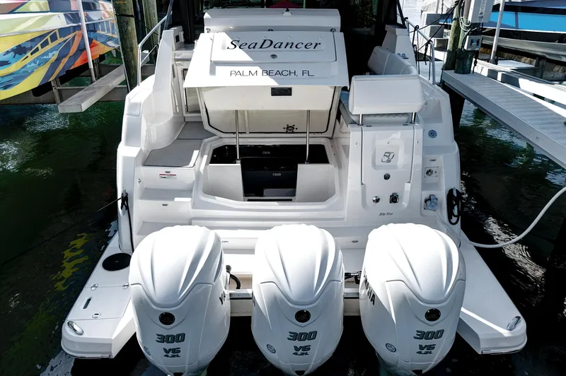 Slide: The Image of 2022 Regal 38 XO boat with triple Yamaha 300 engines, docked in Palm Beach, FL. - 7