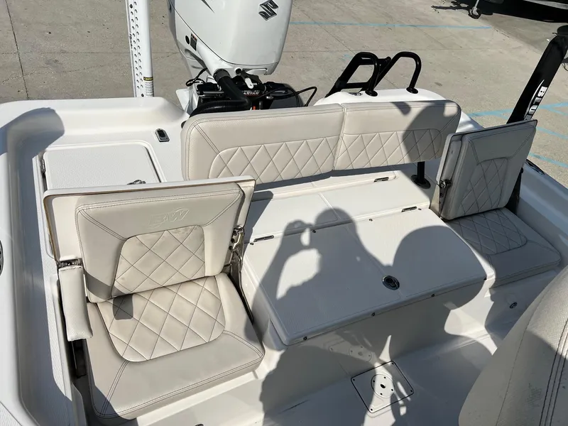 Slide: The Image of 2021 Blue Wave 2400 PURE BAY boat interior with cushioned seating and motor. - 13