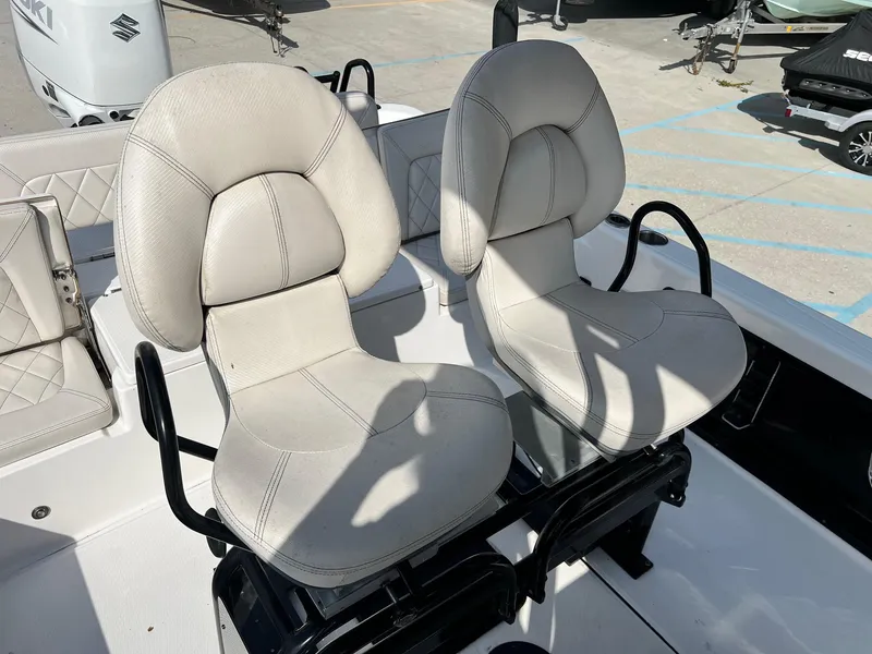 Slide: The Image of 2021 Blue Wave 2400 PURE BAY boat seats, white upholstery, outdoor setting. - 3