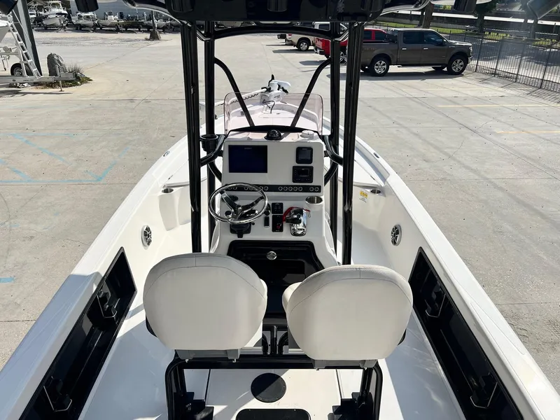 Slide: The Image of 2021 Blue Wave 2400 PURE BAY boat interior with steering console and seating. - 6
