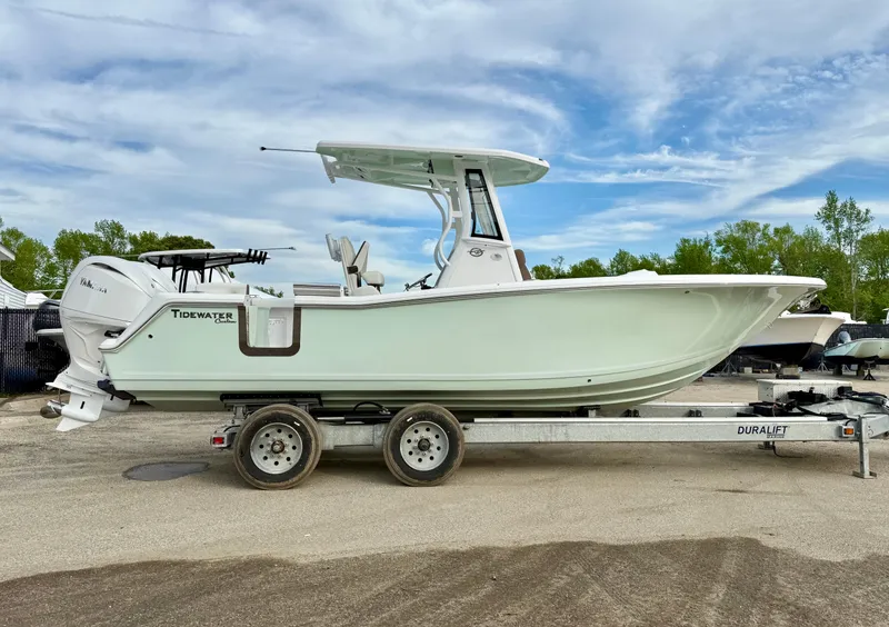 The Image of 2025 Tidewater 256 LXF boat on trailer, side view, under cloudy sky. - 0