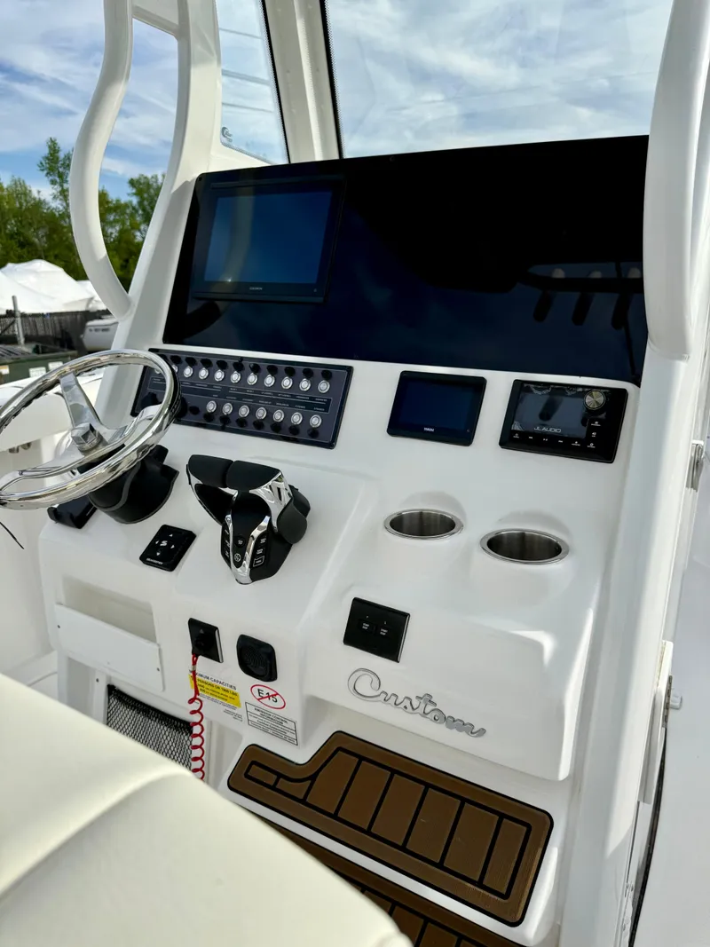 Slide: The Image of 2025 Tidewater 256 LXF boat dashboard with modern controls and navigation screens. - 14