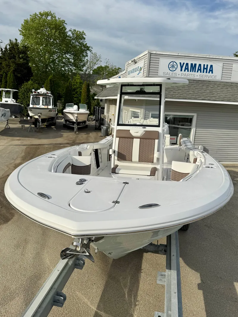 Slide: The Image of 2025 Tidewater 256 LXF boat on trailer at Yamaha dealership. - 22
