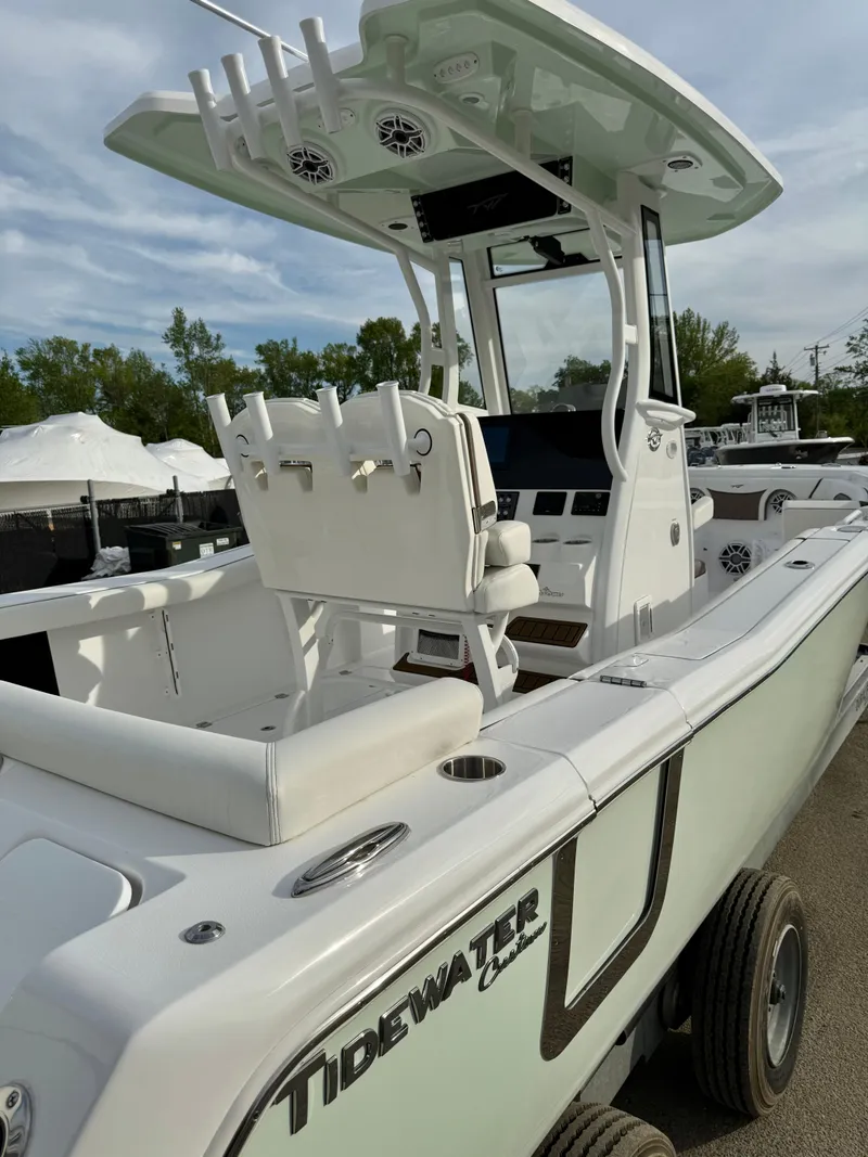 Slide: The Image of 2025 Tidewater 256 LXF boat with sleek design and modern features, docked outdoors. - 24