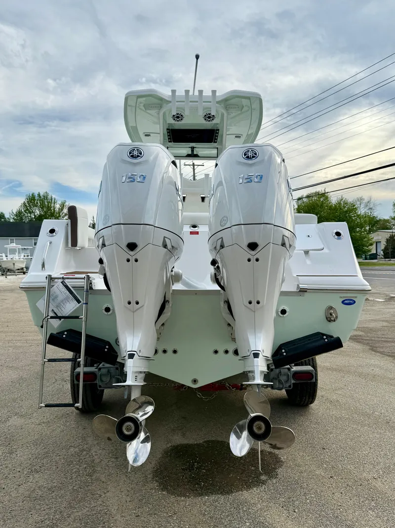 Slide: The Image of 2025 Tidewater 256 LXF boat with dual outboard engines, rear view. - 4