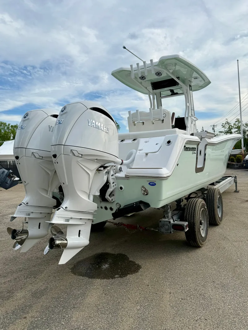 Slide: The Image of 2025 Tidewater 256 LXF boat with dual Yamaha outboard engines on a trailer. - 5