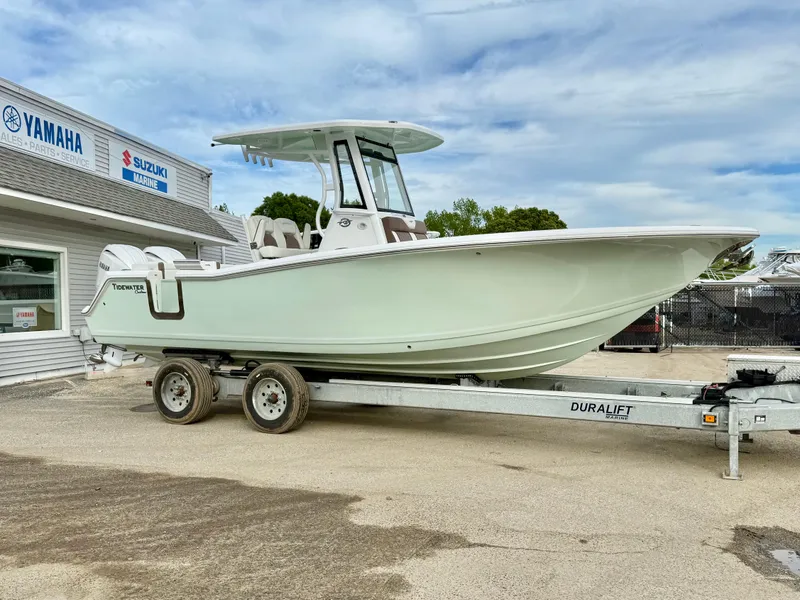 Slide: The Image of 2025 Tidewater 256 LXF boat on trailer, parked outside dealership. - 6