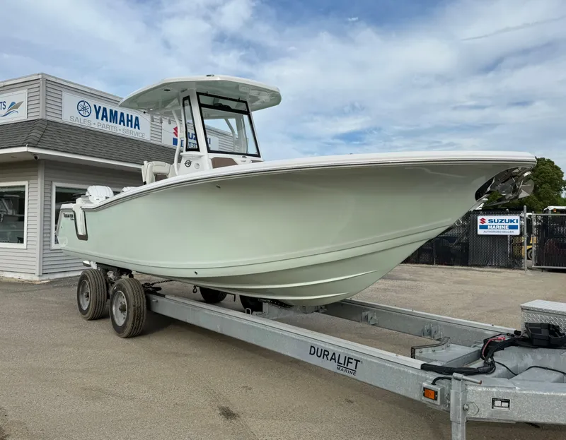 Slide: The Image of 2025 Tidewater 256 LXF boat on trailer at dealership. - 7