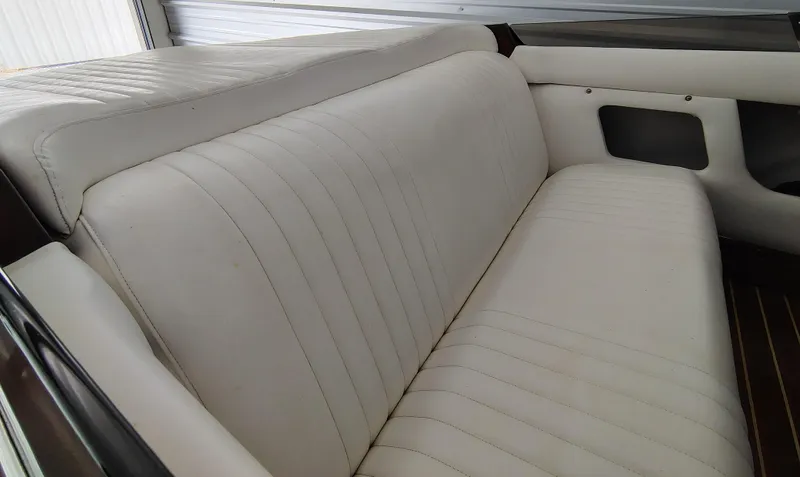 Slide: The Image of 1989 Kavalk Continental interior with white leather seating, showcasing classic design. - 11