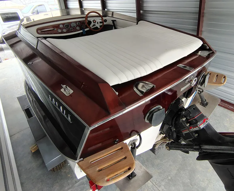 Slide: The Image of 1989 Kavalk Continental boat with wooden finish and white seating, stored in a garage. - 17