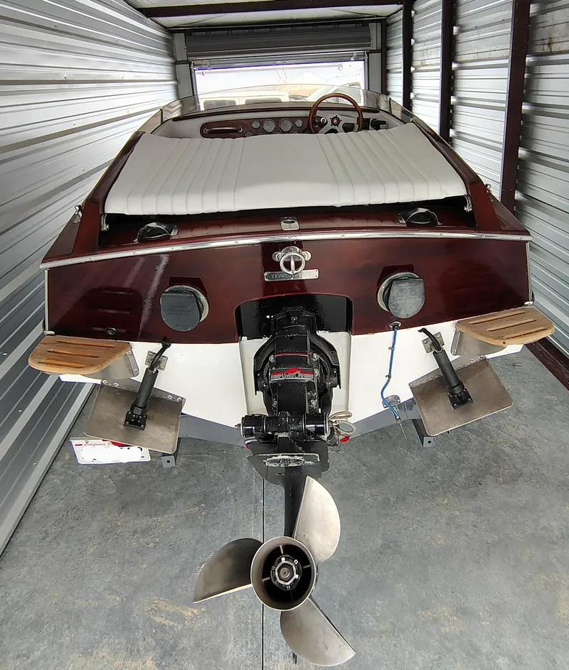 Slide: The Image of 1989 Kavalk Continental boat in storage, showcasing rear view and propeller. - 19