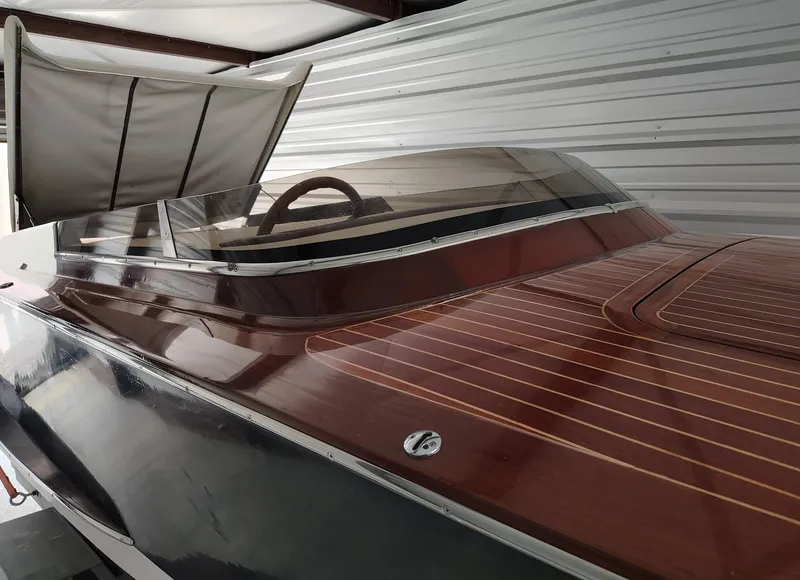 Slide: The Image of 1989 Kavalk Continental boat with wooden deck and sleek design in storage. - 3