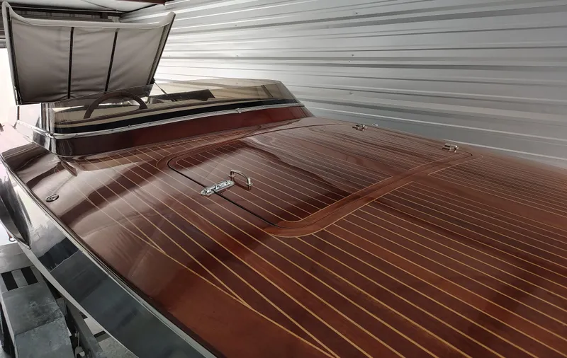 Slide: The Image of 1989 Kavalk Continental boat with polished wooden deck in storage. - 5