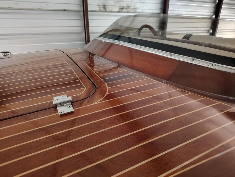 Slide: The Image of 1989 Kavalk Continental boat with polished wooden deck and windshield in storage. - 6