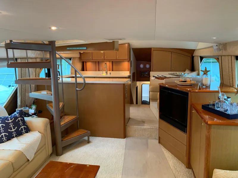 Slide: The Image of Luxurious interior of 2004 Ocean Yachts 57 Odyssey with elegant wood finishes and spiral staircase. - 10
