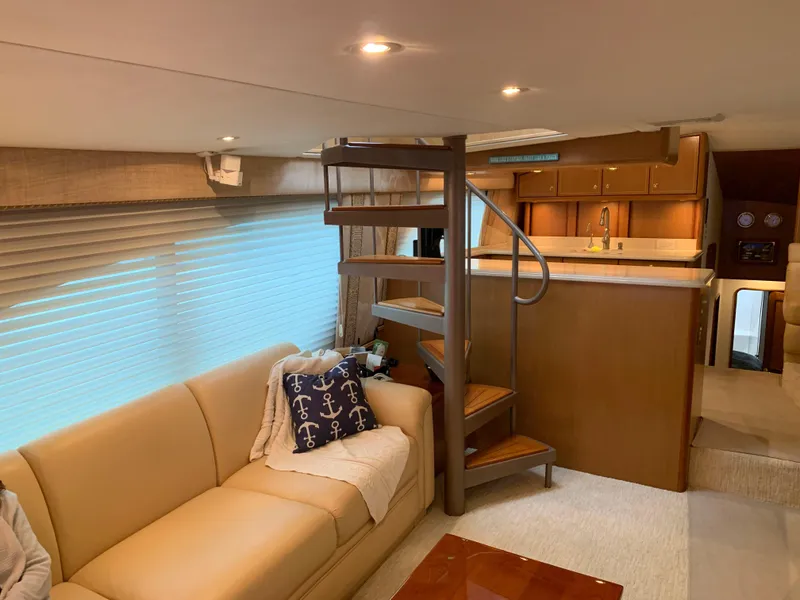 Slide: The Image of Luxurious interior of 2004 Ocean Yachts 57 Odyssey with spiral staircase and cozy seating area. - 11