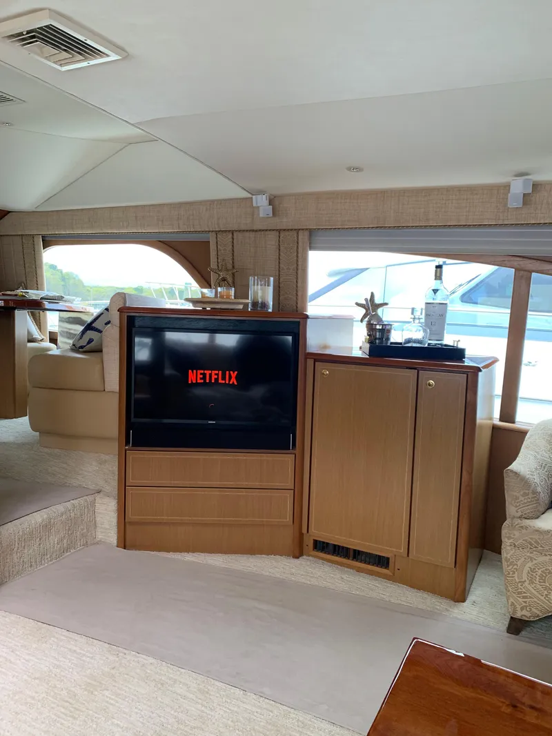 Slide: The Image of Luxurious 2004 Ocean Yachts 57 Odyssey interior with TV displaying Netflix. - 15