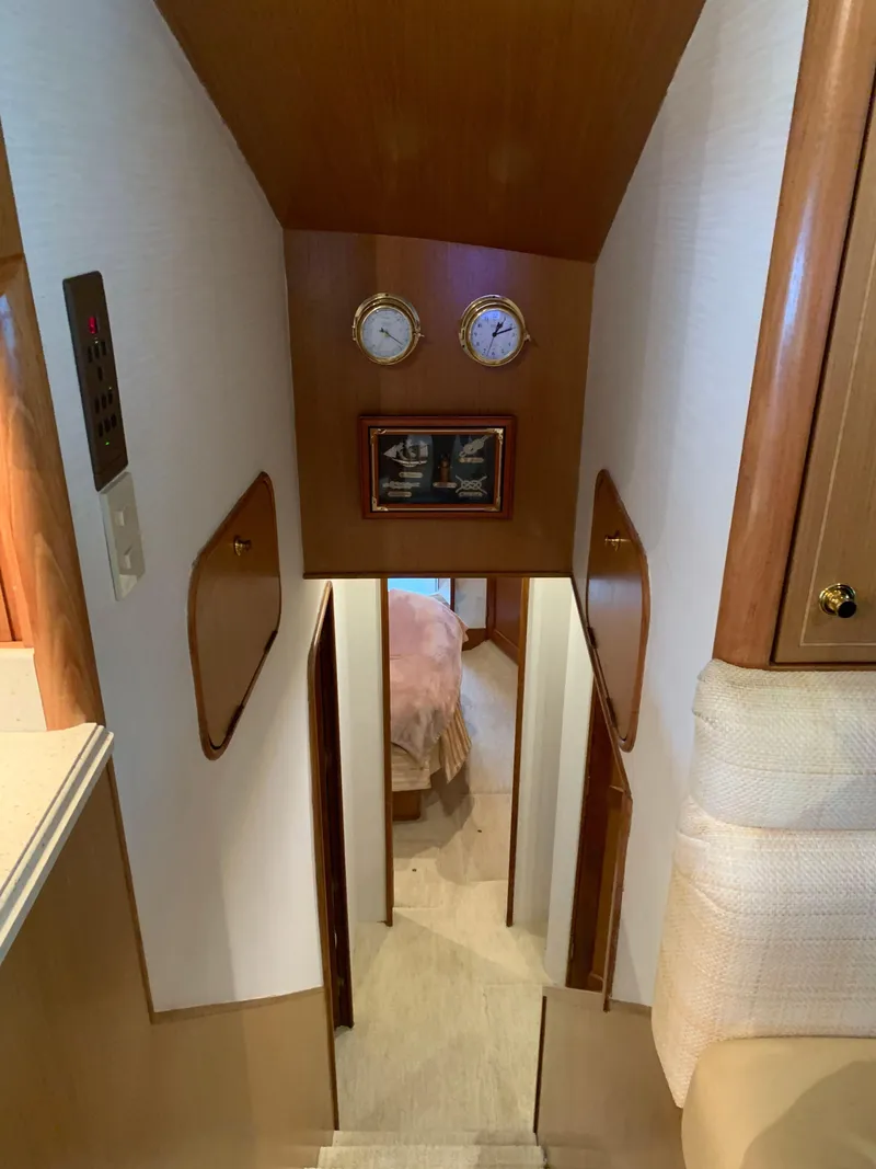 Slide: The Image of Interior view of 2004 Ocean Yachts 57 Odyssey, featuring a cozy cabin hallway. - 24