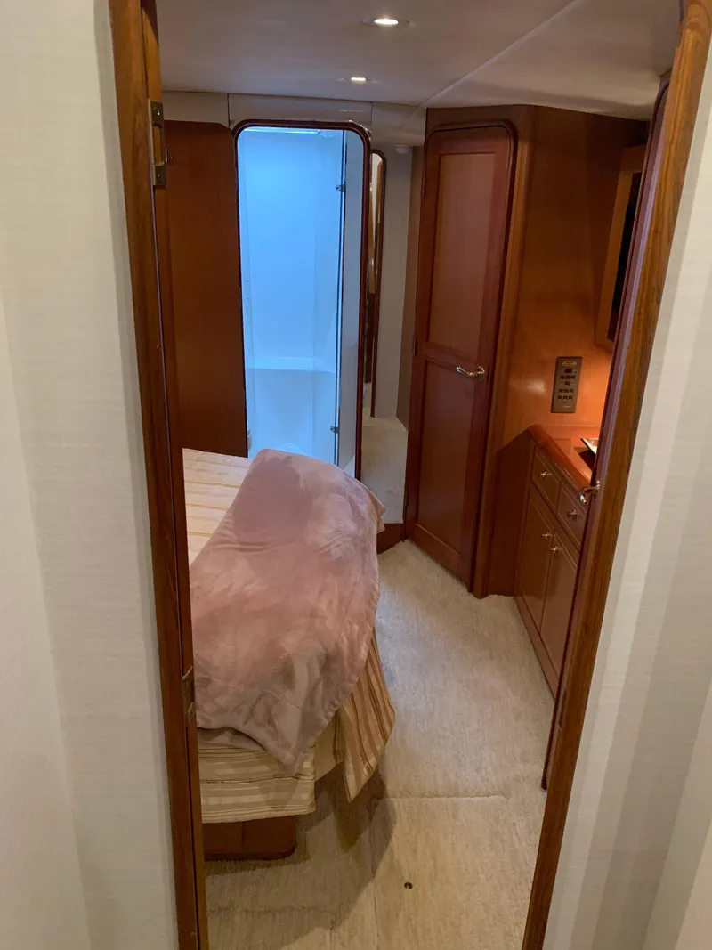 Slide: The Image of Interior of 2004 Ocean Yachts 57 Odyssey, featuring cozy bedroom and wooden cabinetry. - 25