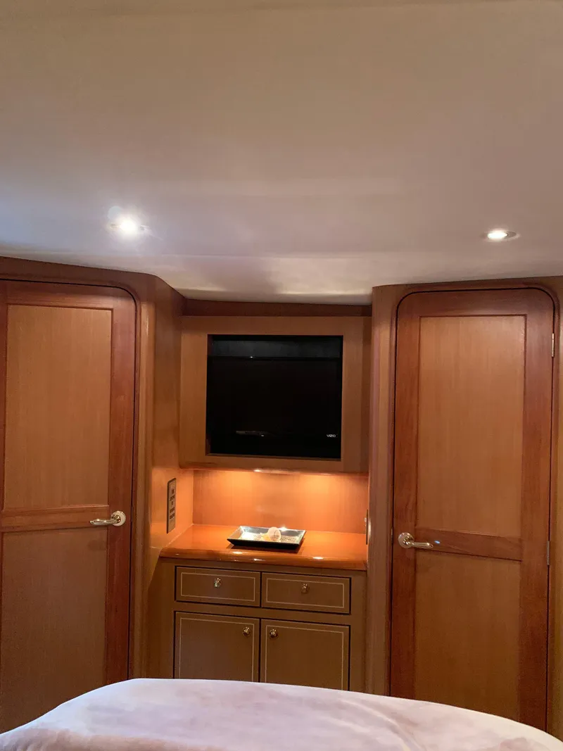 Slide: The Image of Luxurious 2004 Ocean Yachts 57 Odyssey interior with wood cabinetry and built-in TV. - 28