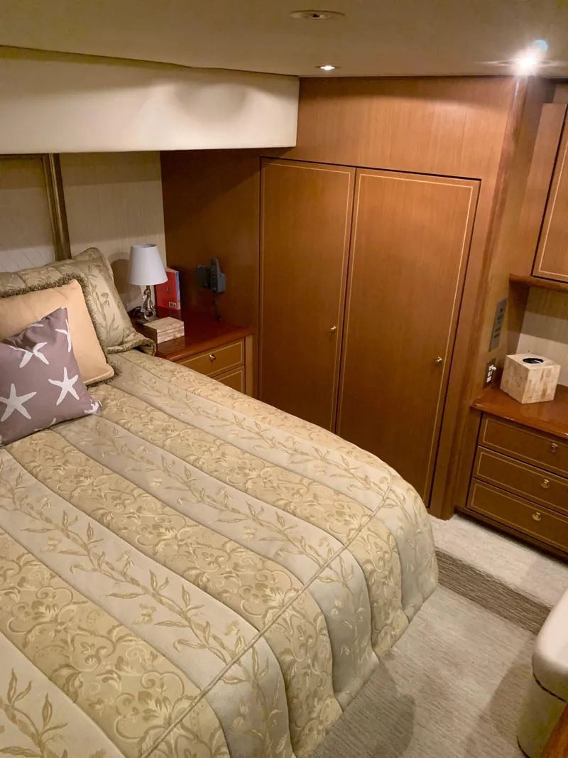 Slide: The Image of Luxurious bedroom in 2004 Ocean Yachts 57 Odyssey with elegant bedding and wooden cabinetry. - 35